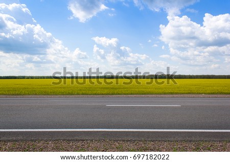 Photo of an empty summer road. On the road there are no cars, the weather is cloudy Royalty-Free Stock Photo #697182022
