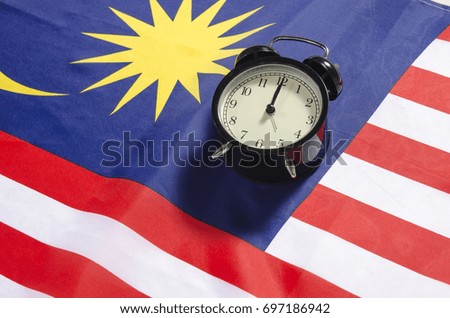 Malaysia Independent day celebration concept, vintage clock on Malaysian Flag