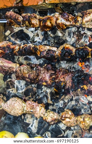 Kebab barbecue on skewers stone oven coal burned pork
