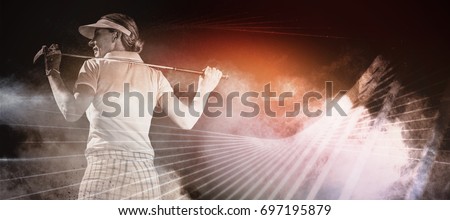 Woman playing golf against digitally generated image of color powder