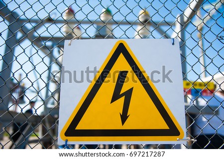Electrical hazard sign placed on a metal fence