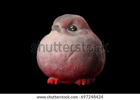 Gypsum sculpture statuette piggy bank pink bird bullfinch on a black background