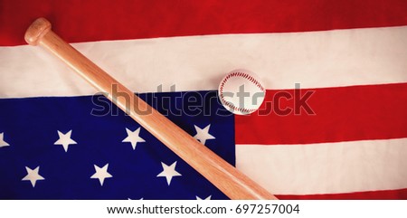 Close-up of baseball ball and bat on national flag