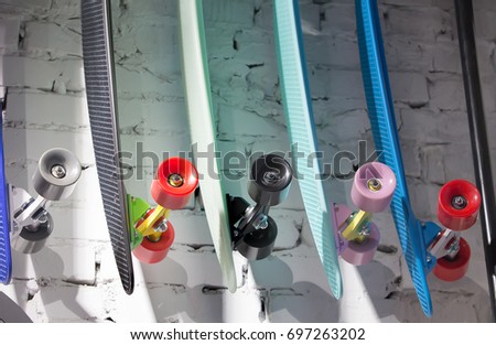 Skateboards with colored wheels on background of brick wall