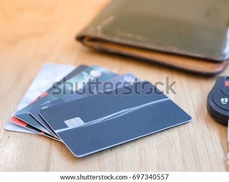 Credit cards (selective focus) on the wooden table together with wallet and car key.
This photo showing concept of customer has many option to manage their finance statement.