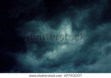 Background of dark clouds before a thunder-storm Royalty-Free Stock Photo #697416337