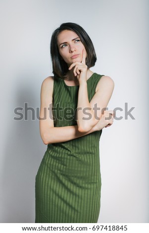 Beautiful young woman has a great idea, isolated on gray background