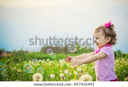 The child blows bubbles. Selective focus.