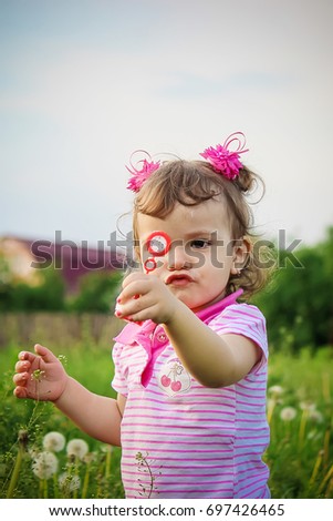 The child blows bubbles. Selective focus.