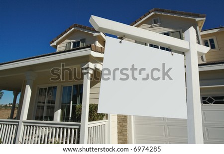 Blank Real Estate Sign and House with dramatic sky background. Ready for your own message.