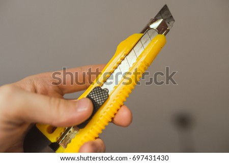 box cutter tool yellow Royalty-Free Stock Photo #697431430