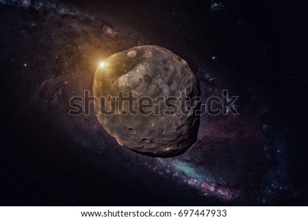 Phobos is the larger and inner of the two natural satellites of Mars, the other being Deimos. Retouched image. Elements of this image furnished by NASA. Royalty-Free Stock Photo #697447933