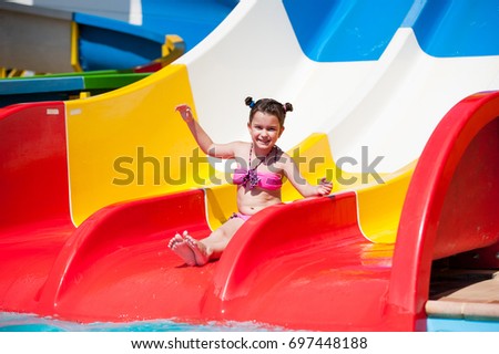 Little beautiful girl goes to the aqua park