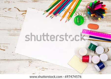 School supplies on a white wooden background with an empty space for inscriptions