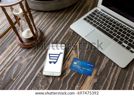 Credit card and mobile smart phone, Online shopping. Concept of time management. Sand clock