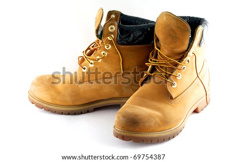 Pair of old yellow working boots Isolated on white background Royalty-Free Stock Photo #69754387