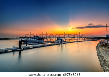 A Long Exposure picture of row of luxury sailboats reflected in water, yacht port on the bay, water transport, ocean transportation, beautiful vessel in the harbor,