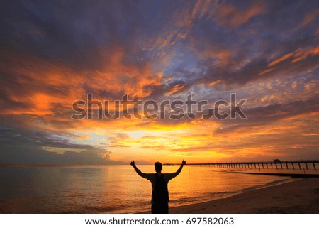 Beautiful sky at twilight time on the sea and silhouette of man is Amazing the twilight