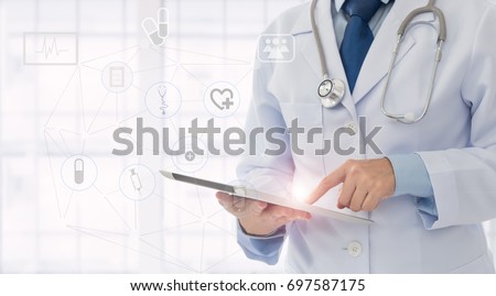 medical technology or medical network. doctor using digital tablet with screen interface.