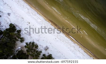 aerial view of frozen beach in winter. drone photography. sea with waves. - panoramic image