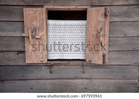 Wooden window on the old wooden wall.