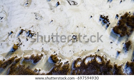 aerial view of frozen forest lake in winter. drone photography. abstract texture - panoramic image
