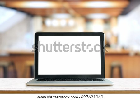 Mock up Blank screen of Laptop on marble table in Co-working or cafe.