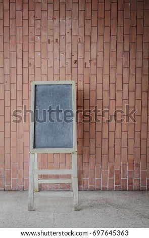 Blackboard signs with a brick wall background.to write a message.