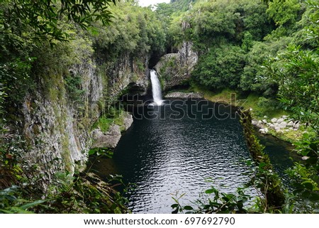 Waterfall at a peaceful waterhole in the tropical forest of La Reunion, France