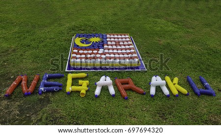 National Day Theme of Malaysia 2017 "Negaraku Sehati Sejiwa"
(My Country, United and Unified) are made using bottles and cans Royalty-Free Stock Photo #697694320