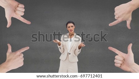 Digital composite of Hands pointing at confused business woman against grey background