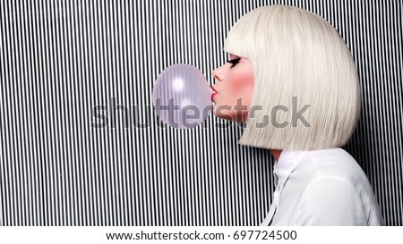 Beautiful girl in white wig blew up in pink gum bubble. A young girl in the studio on a background of a black and white vertical lines. Stylish girl wearing a white shirt. Royalty-Free Stock Photo #697724500