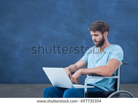 Digital composite of Disabled man in wheelchair on laptop in front of blackboard