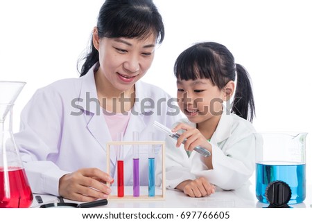 Asian Chinese teacher and little student girl working with test tube in isolated white background