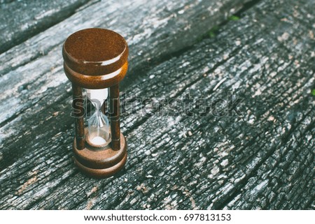 Hourglass, sand glass  on wooden board.