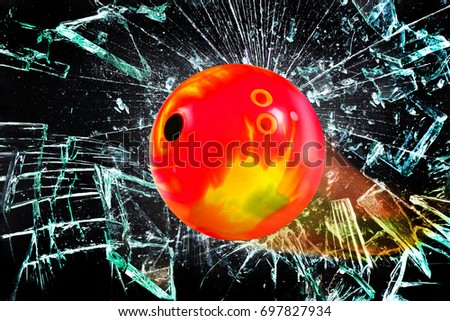 Bowling ball going through broken glass window.