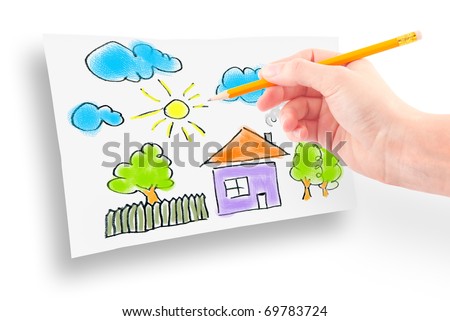 woman's hand with the pencil and brushes drawing the dream home on a white sheet of paper