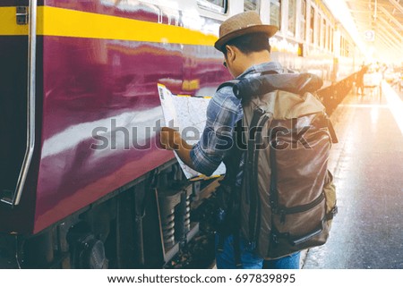 Traveler standing and looking at the map in train station. Travel concept