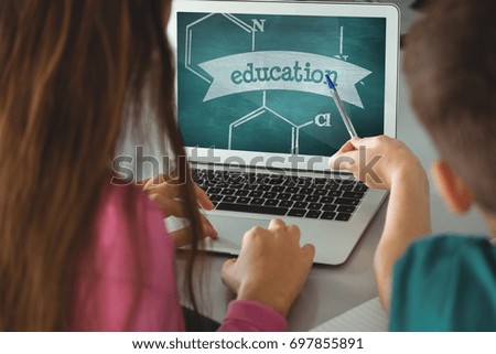 Digital composite of Kids using a computer with school icons on screen