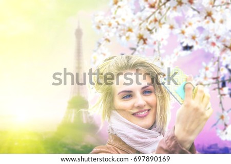 Pretty girl taking selfie in Paris, France at spring sunset with Eiffel Tower on the background