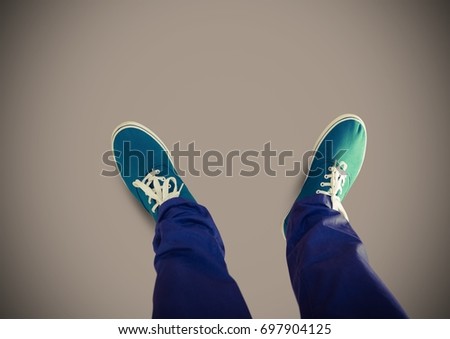 Digital composite of Green shoes on feet with brown background