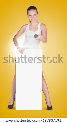 Beautiful young woman with a white empty blank pose in the studio on a yellow background