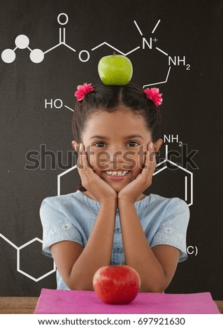Digital composite of Happy student girl at table against grey blackboard with school and education graphic