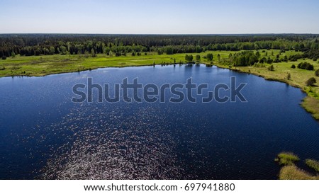 drone image. aerial view of rural area with forest and swamp lake in sunny summer day - panoramic image