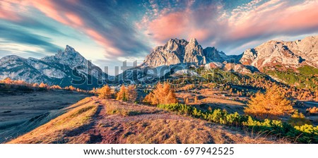Panorama from top of Falzarego pass with Lagazuoi mountain range. Colorful autumn morning in Dolomite Alps, Cortina d'Ampezzo locattion, Italy, Europe. Beauty of nature concept background.
