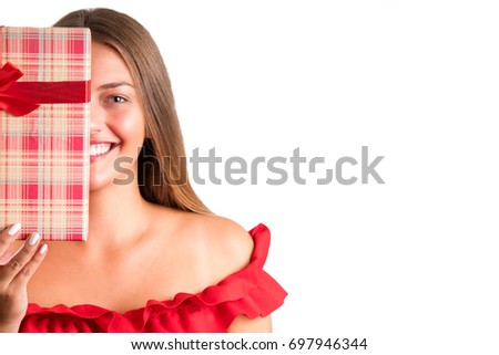 Young smiling model hold gift box. Woman isolated on white background.