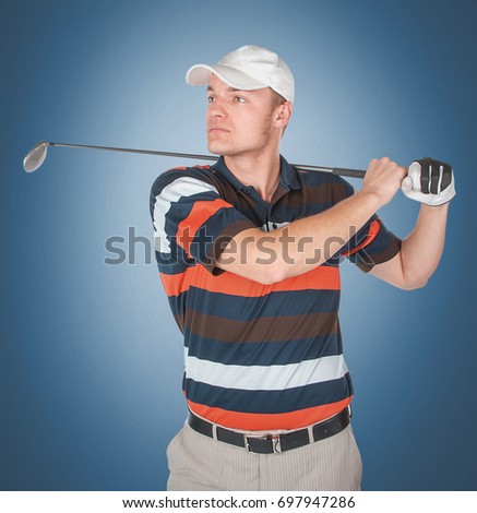 Emotional handsome golfer player pose in studio on blue and green background