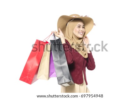 happy muslimah carry tote bag isolated on white background ideal for shopping and lifestyle concept
