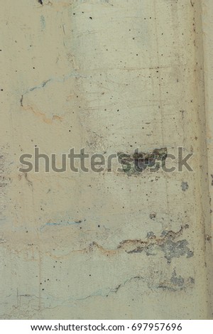 Surface of a textured wall with patches and cracks, background
