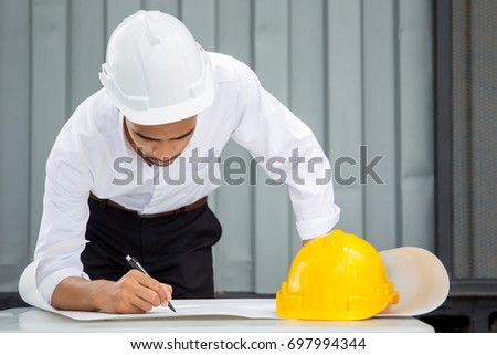 Portrait of the professional engineer working in industry site.